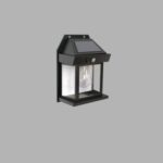 A Koko solar-powered wall lantern, black, with a classic lantern design housing a light bulb and topped with a solar panel, mounted against a plain gray background.