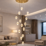Elegant cascading chandelier lighting in a modern double height living room with gold ceiling plate and crystal pendant drops.